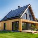 Modern wooden house with solar panels on the roof. 3d rendering.  Eco friendly passive house with a photovoltaic system on the roof.